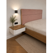 A bed with hanging cabinets